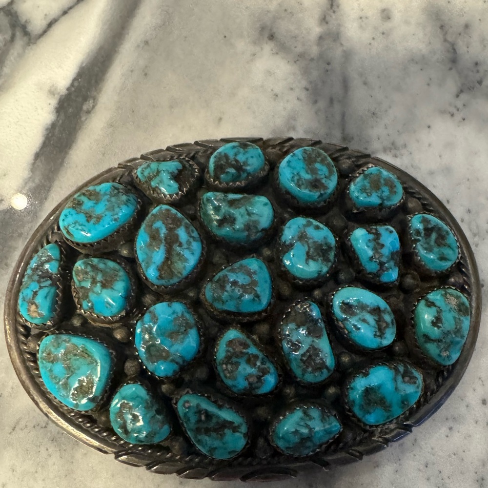 Magnificent vintage sterling buckle.a cluster turquoise stones. Signed L.James
